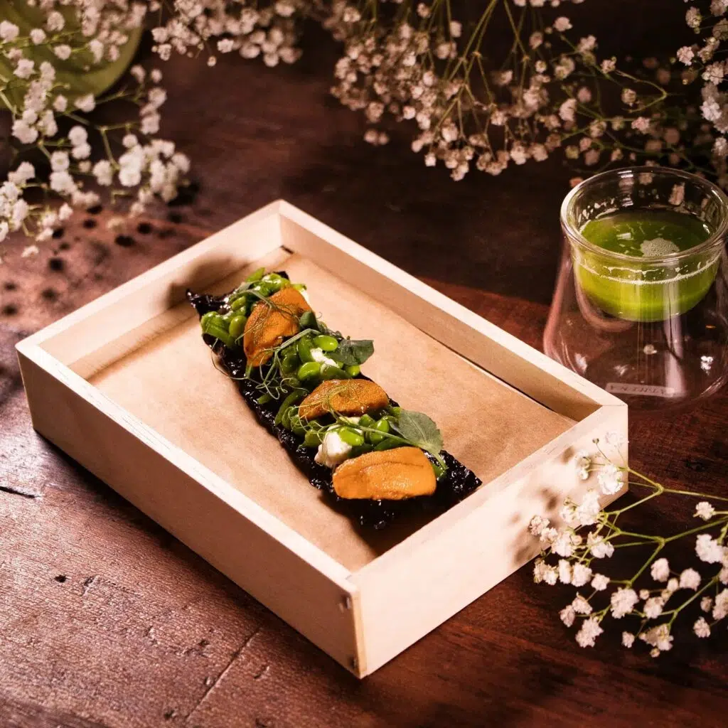 Sugar snap peas with sea urchin and stracciatella on a seaweed crisp. Photo: Lolla / Facebook