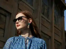 a woman wearing sunglasses and a blue shirt