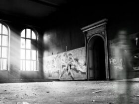 grayscale photo of person standing inside building