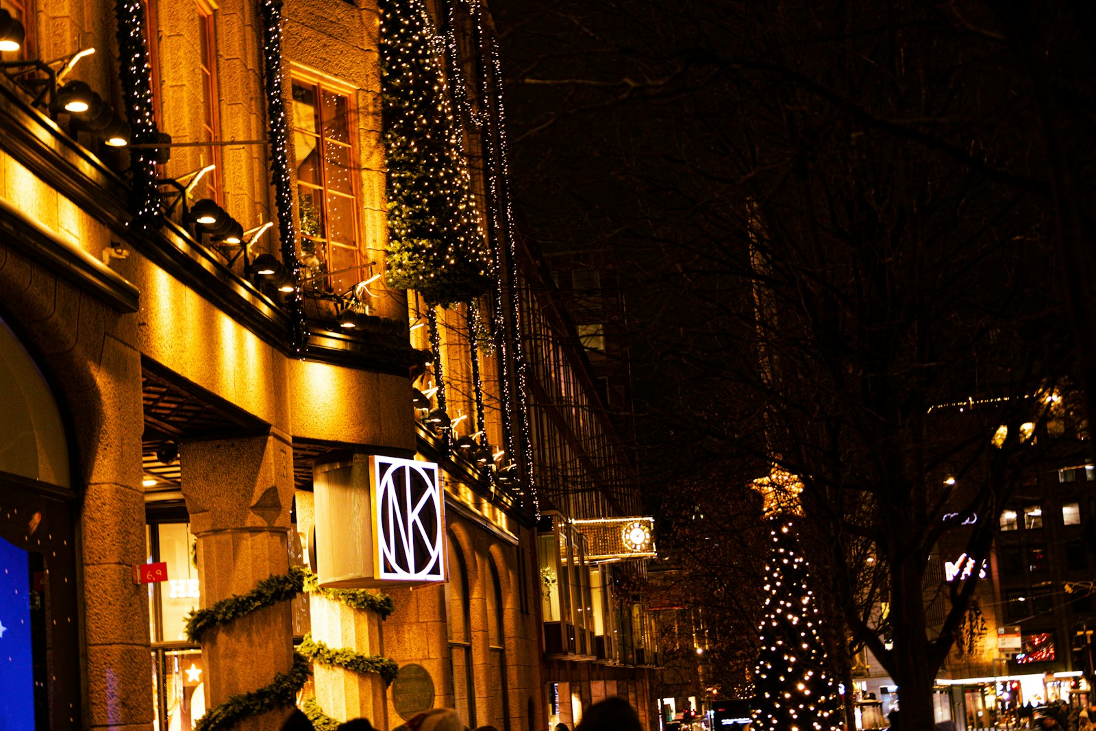 a christmas tree is lit up on a city street